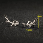 Silver antler-shaped earrings on a dark textured background with measurements indicated.